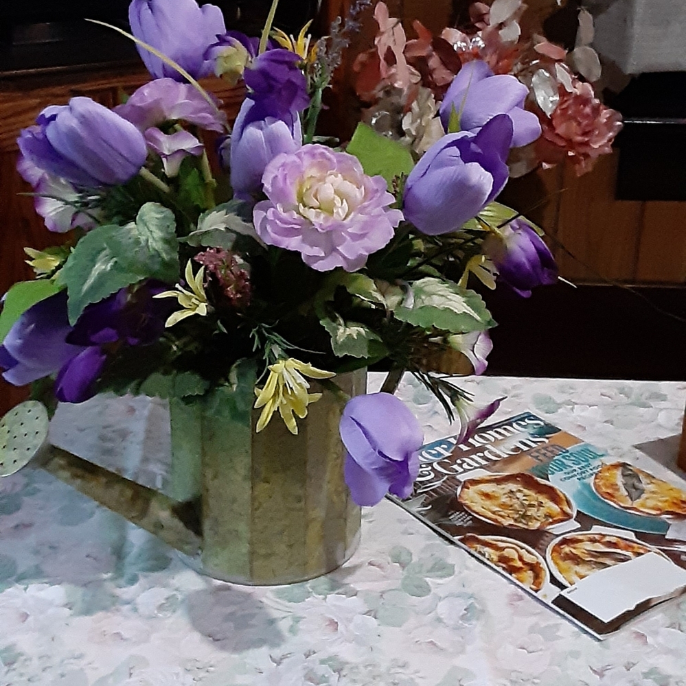 Silk flower arrangement in watering can